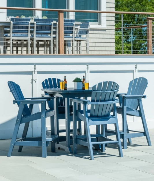 Outdoor bar height patio set with blue chairs and table on a deck.